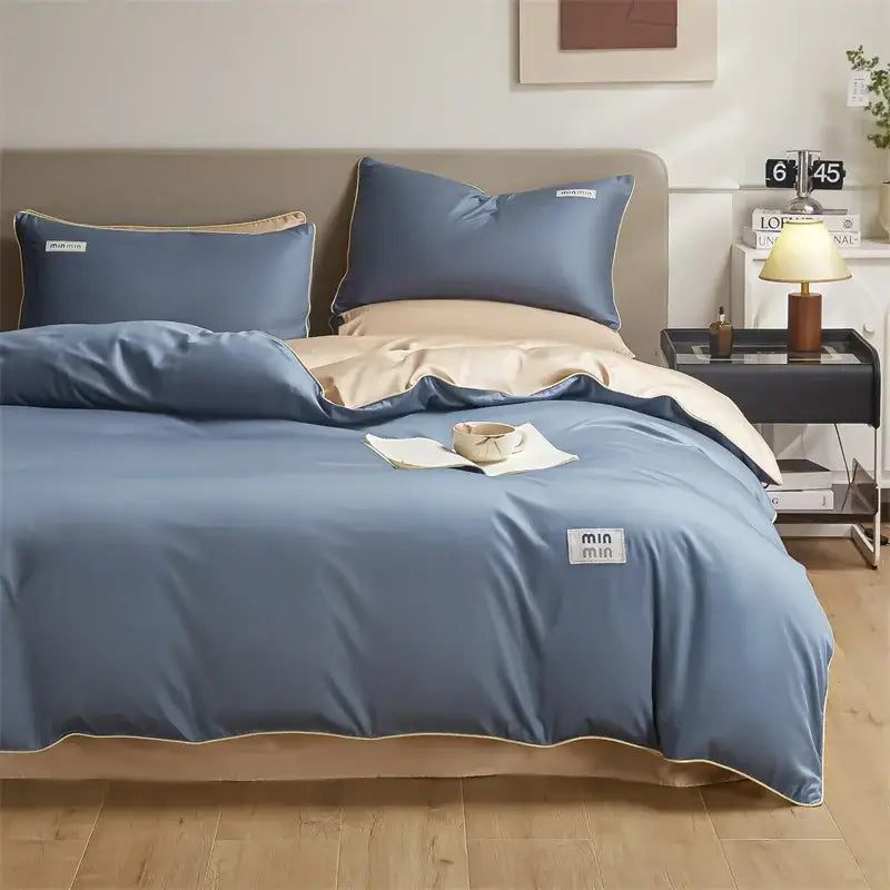 Blue and beige two-tone egyptian cotton solid bedding set with subtle min min label for minimalist bedroom