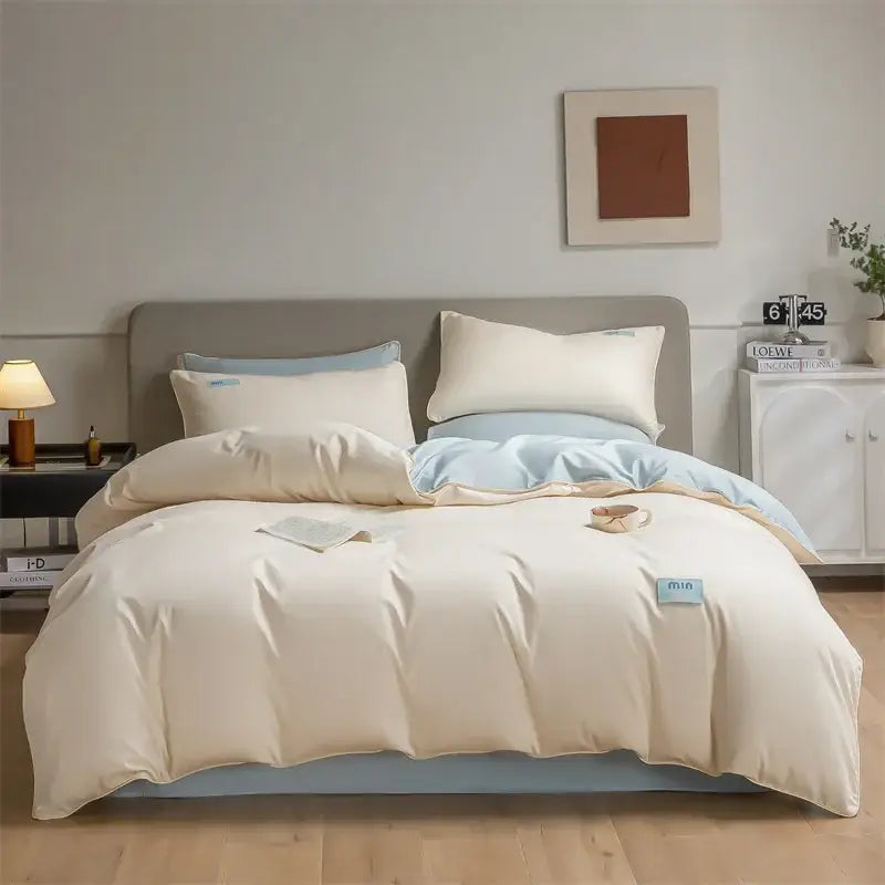 Cream-colored satin duvet cover bedding set with light blue accents and embroidered tags in egyptian cotton solid style