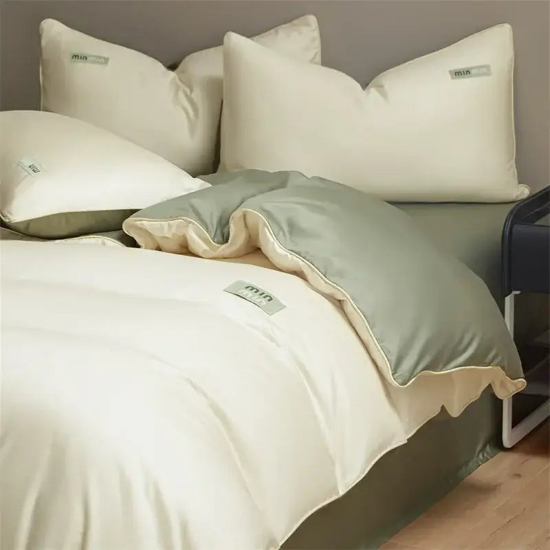 Cream-colored satin duvet cover with ruffled edge and matching pillowcases in minimalist egyptian cotton solid bedding set