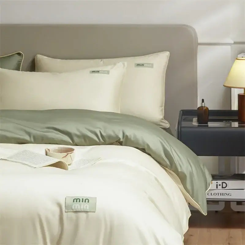 Minimalist cream and green egyptian cotton solid bedding set with cream satin duvet and sage green accents by Mia