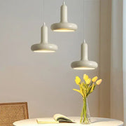 Three cream white ceramic pendant lights with a disc shaped minimalist design for dining room decorbites pendant light