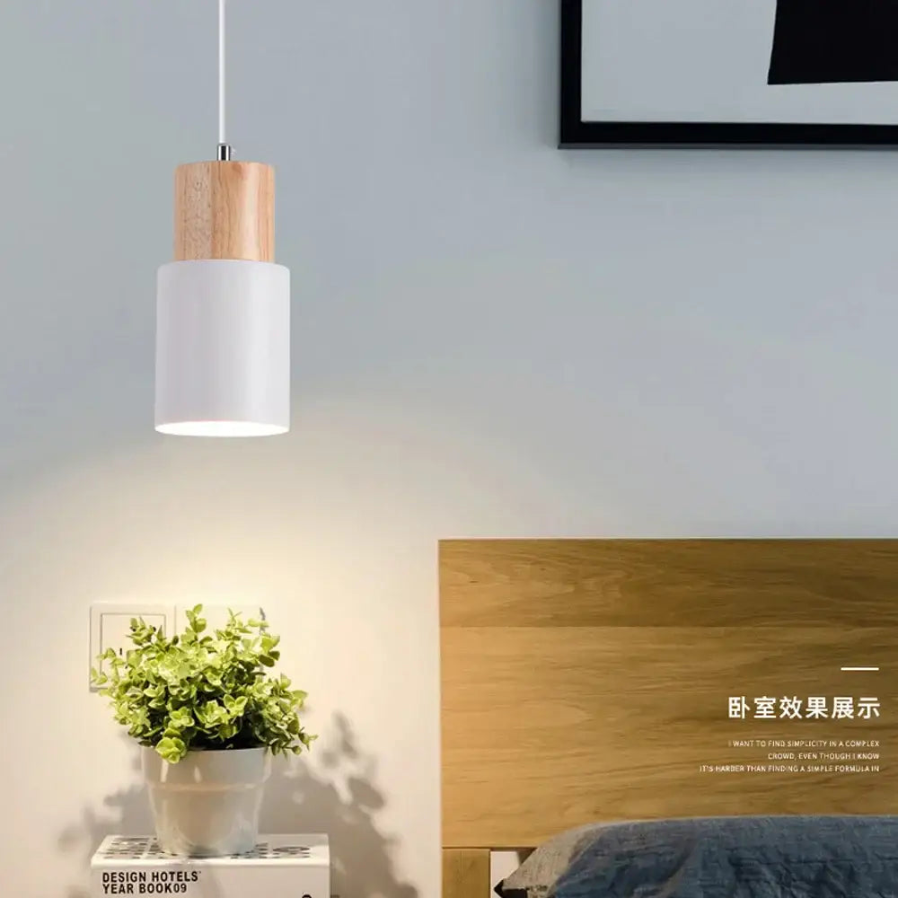 Minimalist pendant light with natural wood accent and crisp white matte cylindrical shade for kitchen island lighting