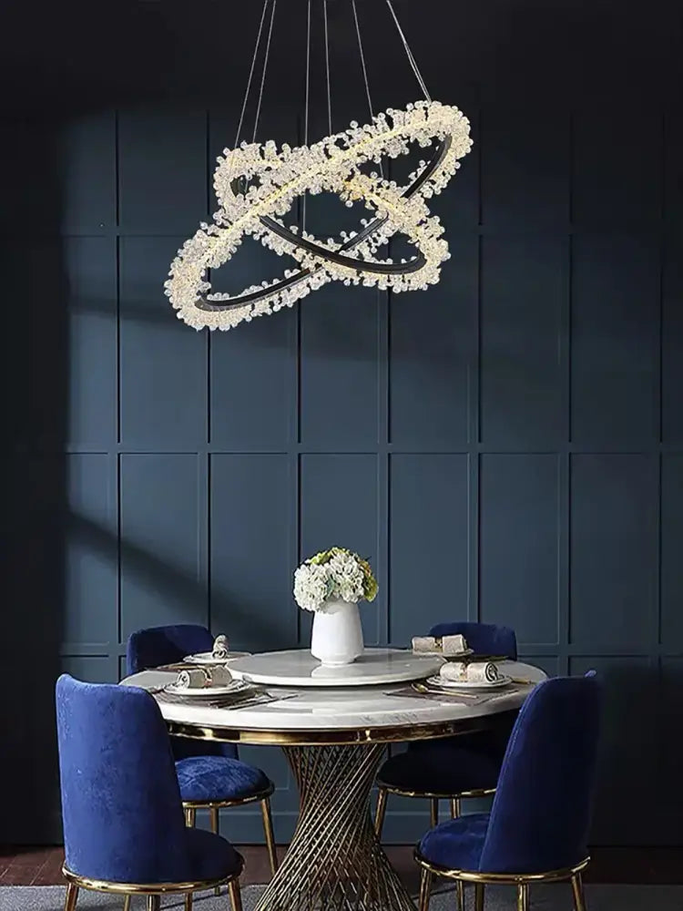 A modern minimalist crystal gold black ring chandelier with interlocking rings and sparkling clear crystals for dining room decorbites
