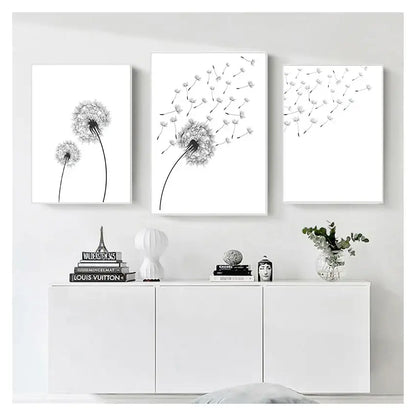 Three minimalist black and white dandelion canvas wall art prints in white frames by DecorBites™
