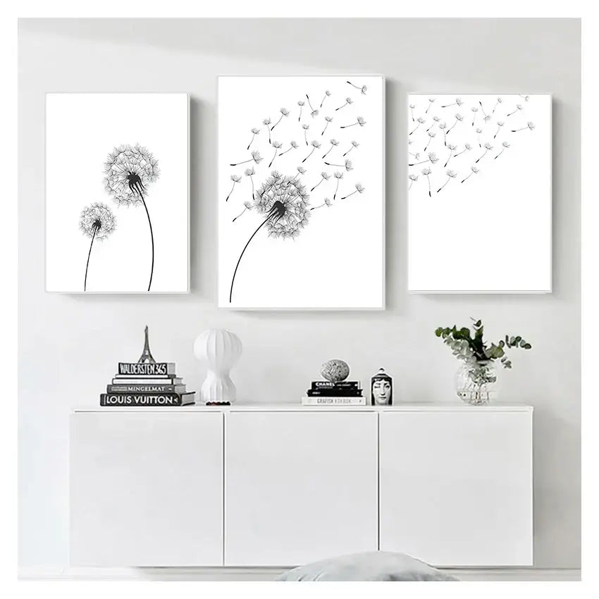 Three minimalist black and white dandelion canvas wall art prints in white frames by DecorBites™