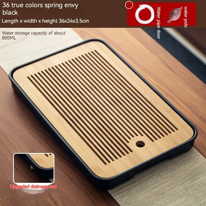 Minimalist dark brown and black rectangular bamboo tea tray with black plastic edges and parallel drainage slits