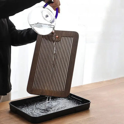 Minimalist dark brown bamboo tea tray with vertical slits and a red knob for dining room storage use