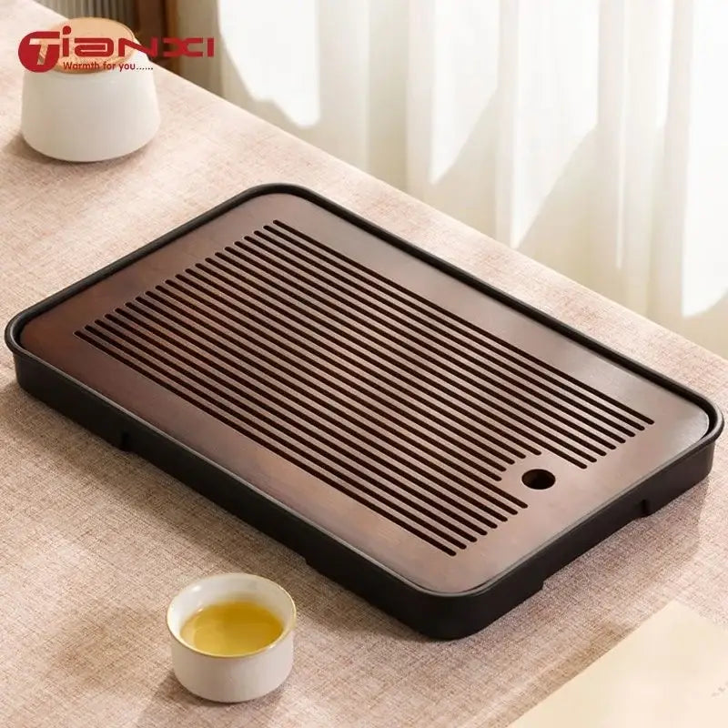Minimalist dark brown and black bamboo tea tray with sleek rim and parallel drainage grooves for dining room storage