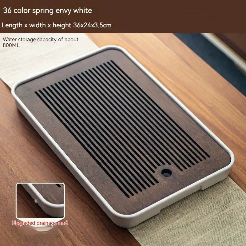 Minimalist dark brown and black bamboo tea tray with white plastic frame and black slatted drainage for dining storage