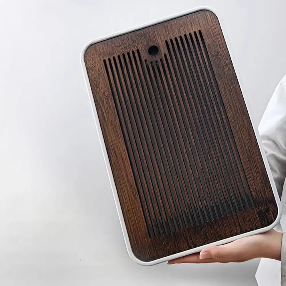 Minimalist rectangular bamboo tea tray with dark brown grainy surface and white plastic border for dining room storage