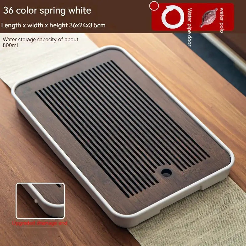Minimalist dark brown and black bamboo tea tray with white plastic frame and parallel slits for water drainage