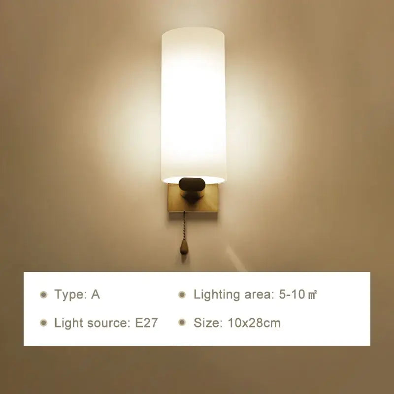 Minimalist warm-toned wooden wall lamp with frosted glass shade brass finish and pull chain for bedroom use