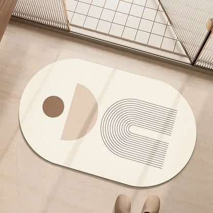 Minimalist geometric diatom ooze bathroom rug in cream and beige with abstract black and beige line designs on white oval mat