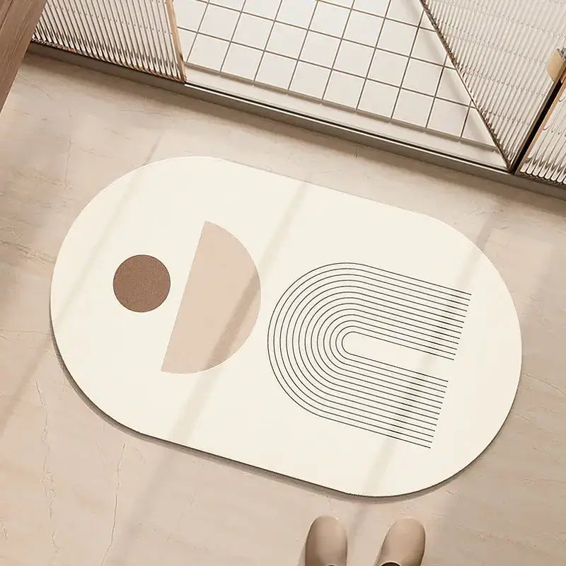 Minimalist geometric diatom ooze bathroom rug in cream and beige with abstract black and beige line designs on white oval mat