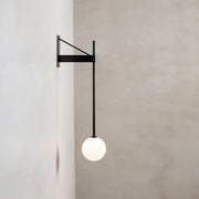 Minimalist geometric iron wall lamp featuring a black metal frame and spherical frosted glass globe for bedroom decorbites wall lamp