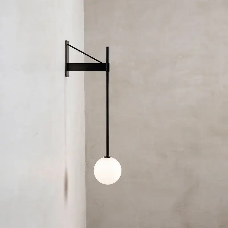 Minimalist geometric iron wall lamp featuring a black metal frame and spherical frosted glass globe for bedroom decorbites wall lamp