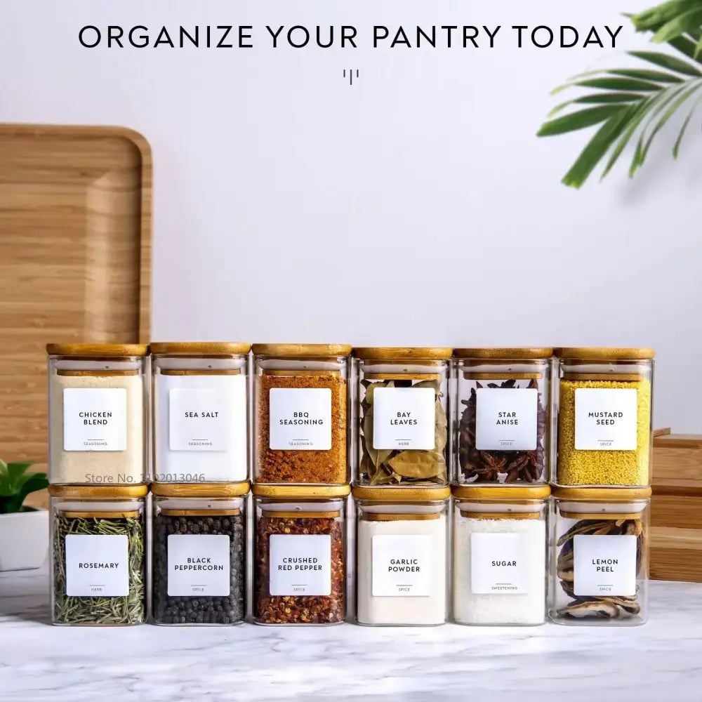 Set of clear decorbites glass jars with bamboo lids and white labels for minimalist kitchen storage of spices