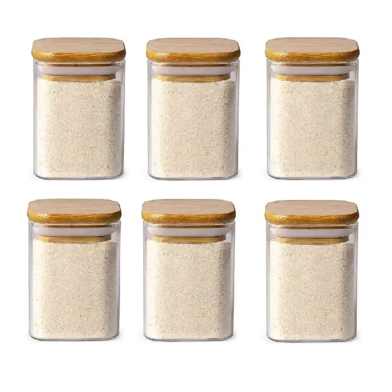 Set of six minimalist decorbites glass jars with bamboo lids filled with white rice for kitchen storage