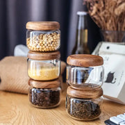 Minimalist clear glass spice jar with smooth rounded acacia wood lid for elegant kitchen storage