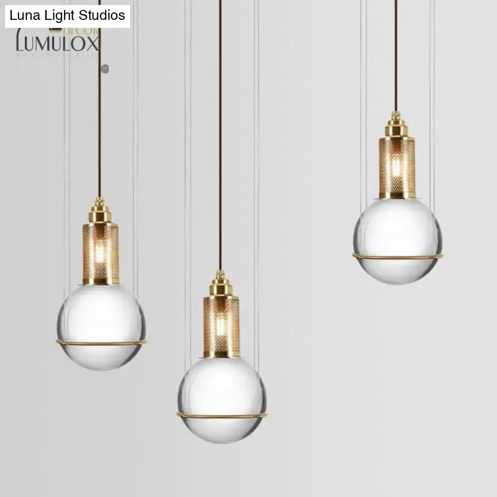 Three elegant gold-toned hanging lamps with crystal globe shades for minimalist living room decor by decorbites