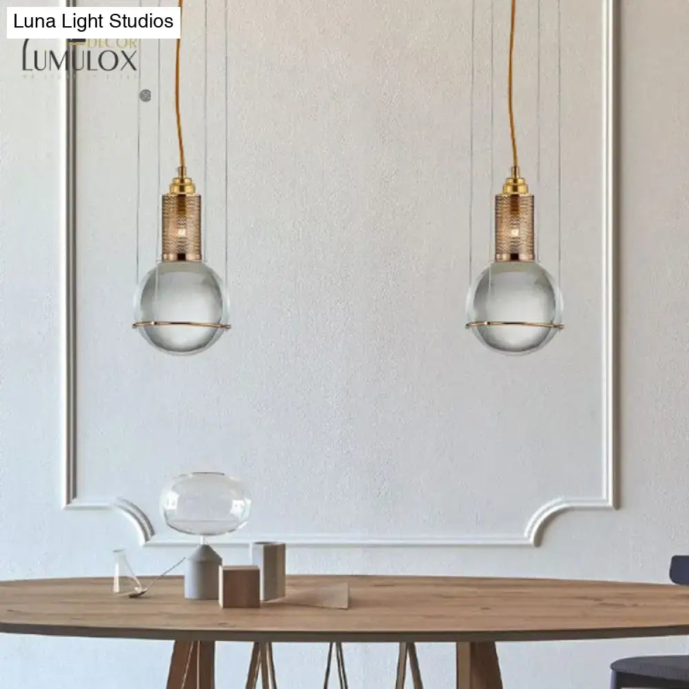 Two elegant decorbites™ hanging lamps with crystal shade and gold-toned brass finish for living room lighting