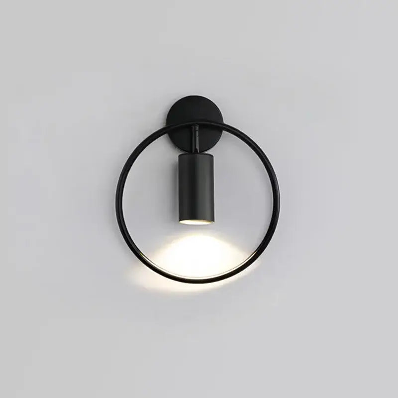Black circular decorbites wall light with adjustable angle and matte finish for minimalist bedroom sconce decor