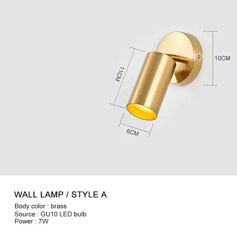 Brass-finished decorbites wall light with cylindrical design and adjustable angle for minimalist bedroom sconce decor