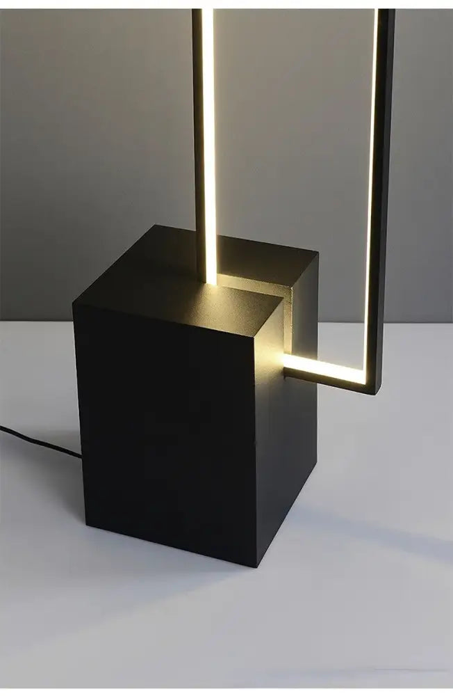Black cube-shaped floor lamp with illuminated gold and black decorbites geometric led vertical strips for living room decor