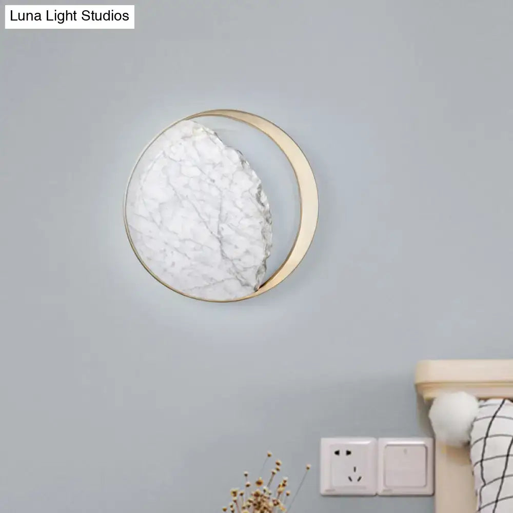 Minimalist gold and white moon wall lamp with a circular marble textured face for living room wall lamp decor