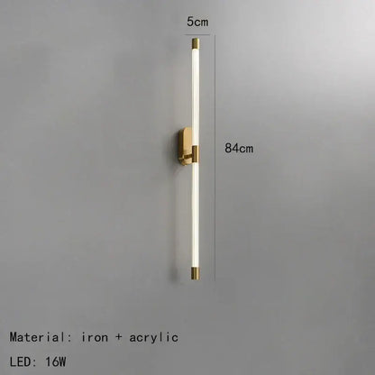 A sleek minimalist gold and black decorbites acrylic line led wall light with brass iron base and acrylic diffuser tube