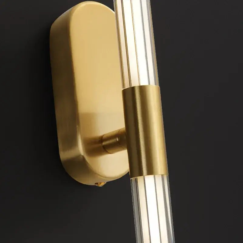Gold-toned decorbites acrylic line wall lights with sleek rectangular backplate and clear acrylic rods for bedroom lighting