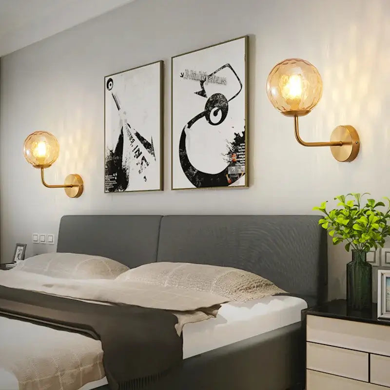 Minimalist gold and black wall lamp with a gold-toned decorbites glass ball led globe for bedroom lighting decor