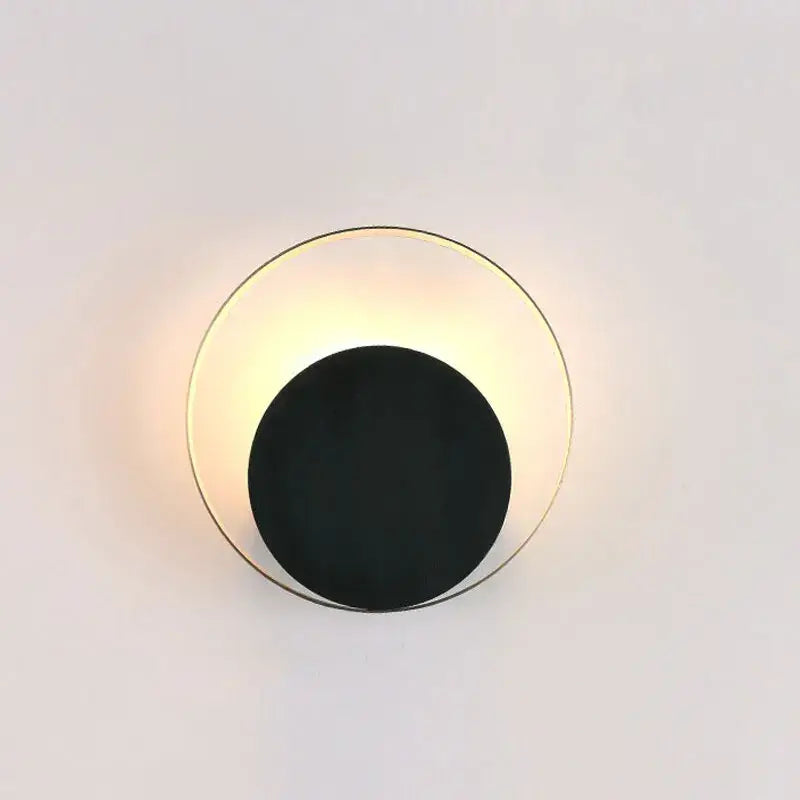 Minimalist gold and black led wall lamp with a circular design for modern living room use