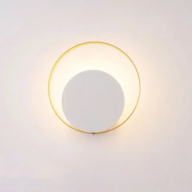 Minimalist gold and black led wall lamp with a circular metal frame and soft white light for living room use