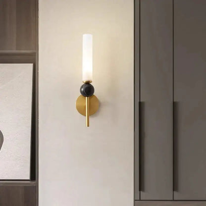 Minimalist gold copper wine corridor wall lamp featuring a frosted glass cylinder and black spherical accent by decorbites