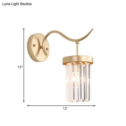 Minimalist gold wall mount light featuring a curved arm with vertical crystal prisms for bedroom use
