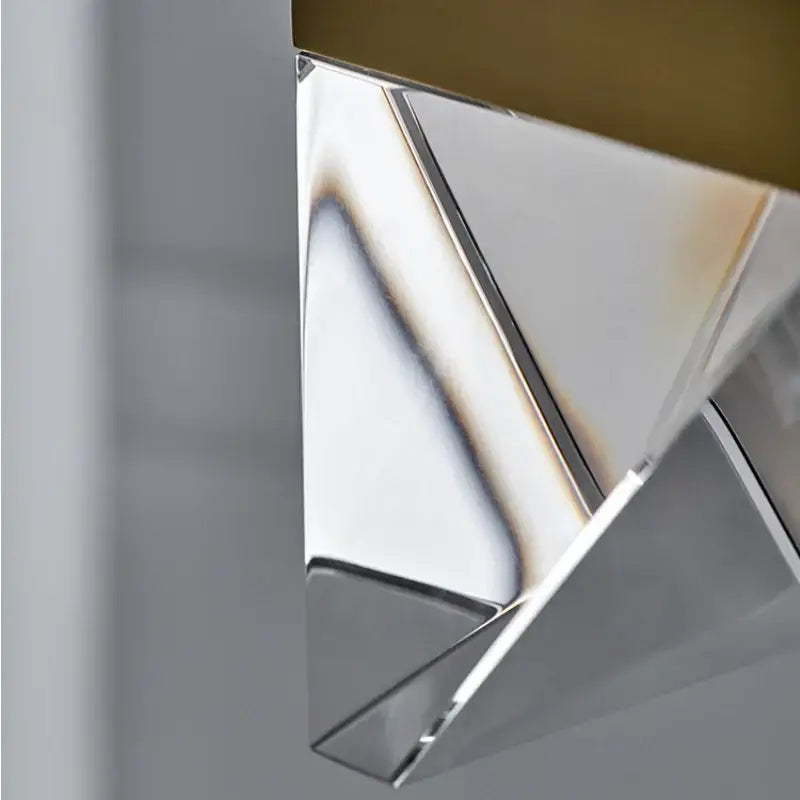 A sleek decorbites crystal chandelier lampshade with polished chrome finish and gold-toned top for minimalist decor