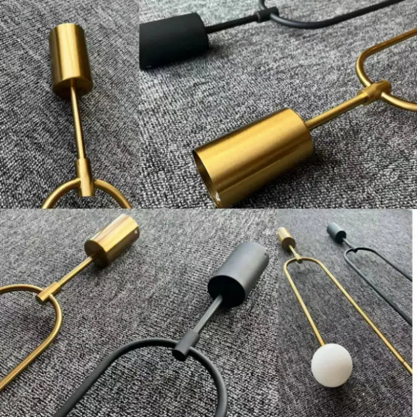 Minimalist gold double head glass ball pendant light with cylindrical shade and sleek metal frame for bedroom use