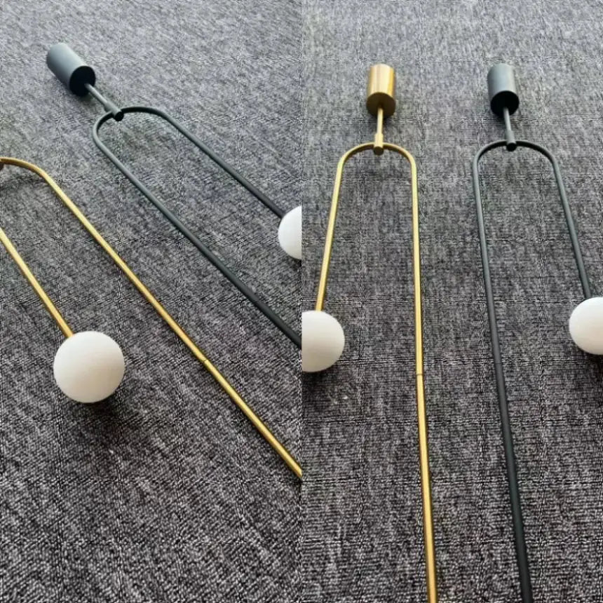 Minimalist gold pendant lights with double head glass ball design and sleek u-shaped metal frame for bedroom