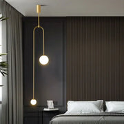 Minimalist gold double head glass ball pendant lights with spherical bulbs and curved metal arm for bedroom lighting