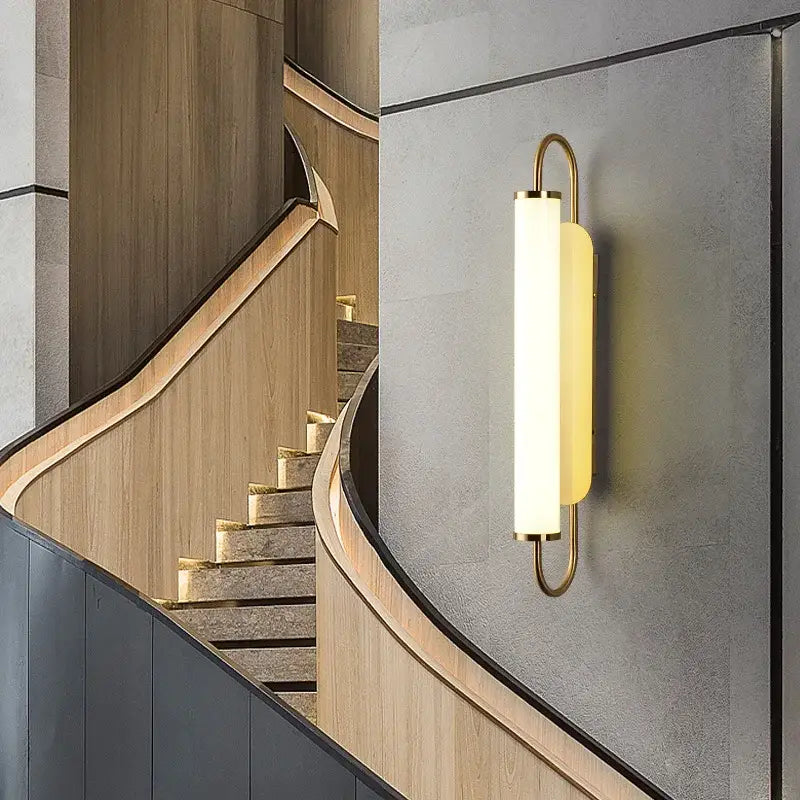 Minimalist gold elegant wall sconce with frosted glass diffuser and curved metal frame for bedroom decorbites elegant wall