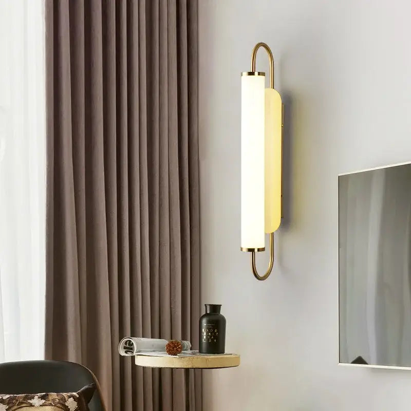 Minimalist gold elegant wall sconce with a sleek metal frame and frosted glass diffuser for bedroom decorbites elegant wall use