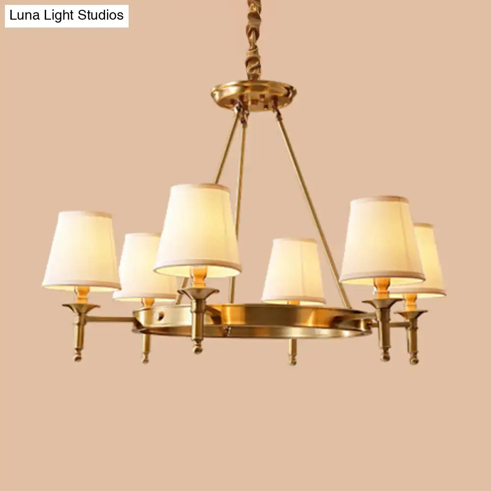 Brass-finished minimalist conical ceiling chandelier with six cream fabric bedroom shades for elegant lighting