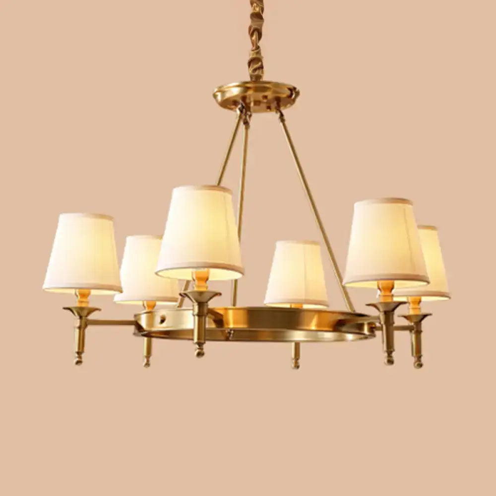 Brass-finished minimalist conical ceiling chandelier with six cream fabric shades for fabric bedroom lighting