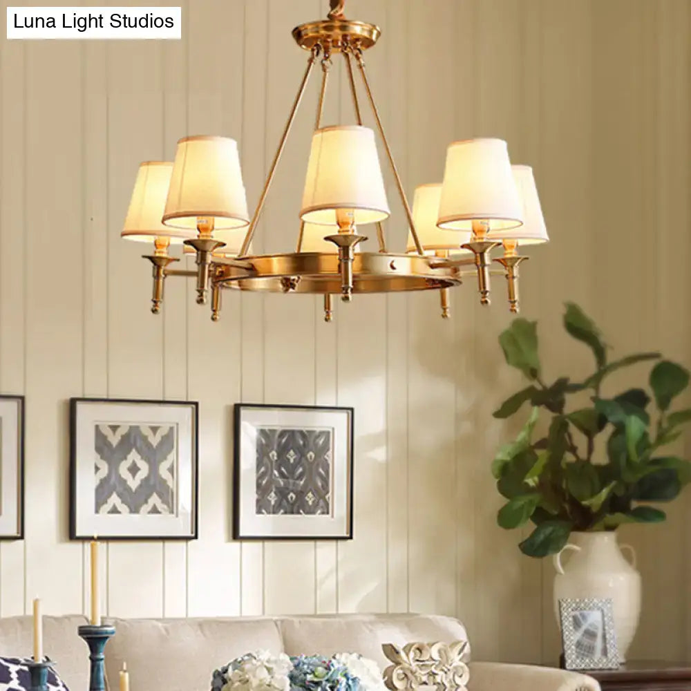 Brass-finished minimalist conical ceiling chandelier with six cream fabric bedroom shades for elegant lighting