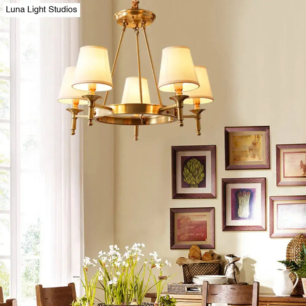 Minimalist gold fabric bedroom conical ceiling chandelier with brass frame and five cream-colored lampshades