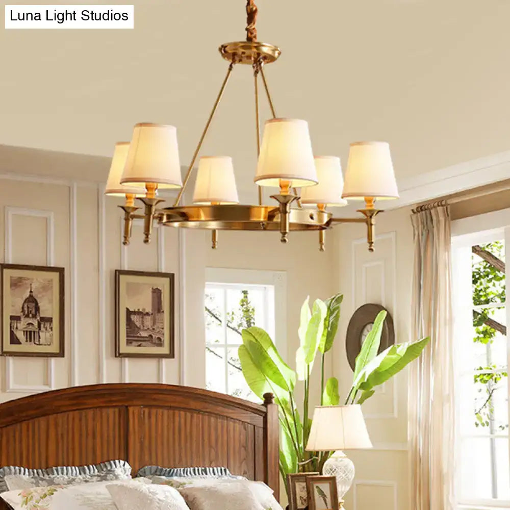 Brass minimalist conical ceiling chandelier with six cream fabric bedroom shades in gold finish
