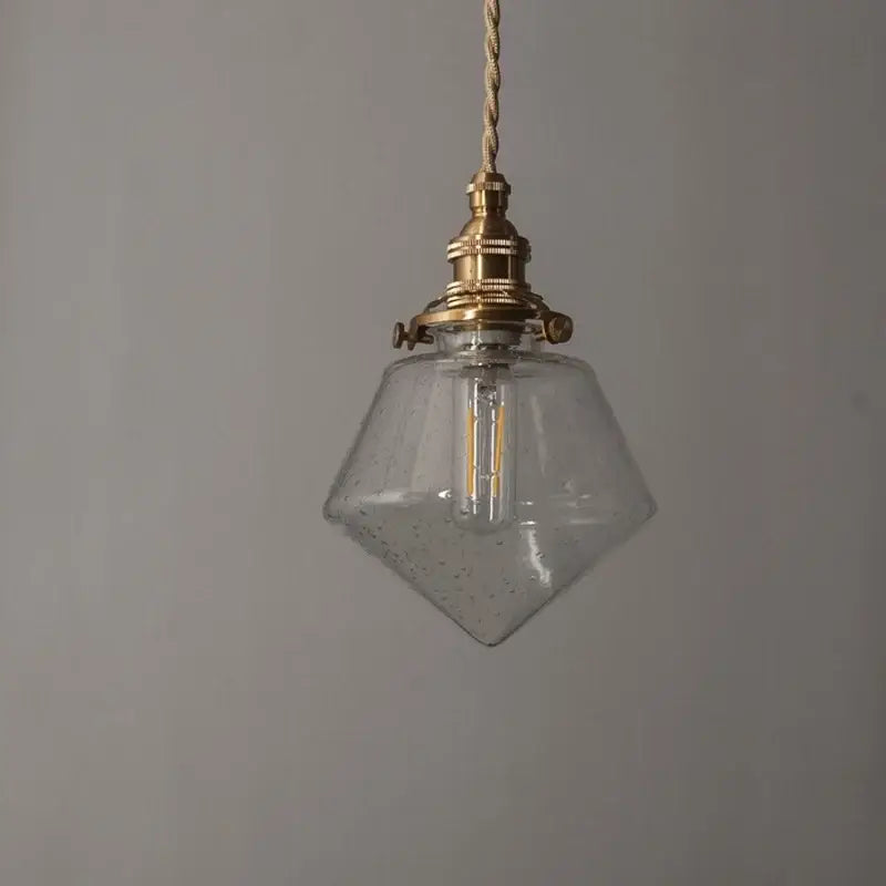 Minimalist gold faceted bubble glass led hanging light with brass fixture and exposed filament bulb for dining room
