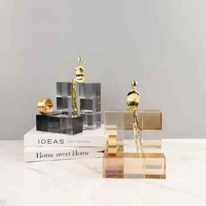 Minimalist gold geometric stair crystal ornament featuring abstract human figurines on acrylic cube bases for decorbites decorbites geometric stair