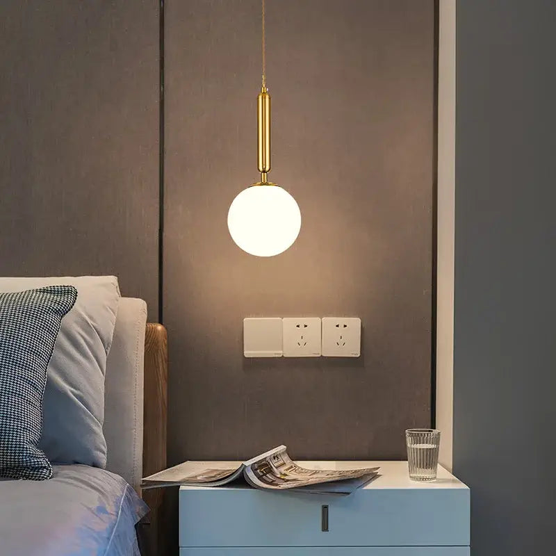 Minimalist gold glass ball led chandelier featuring a gold-toned pendant light with a frosted glass ball globe